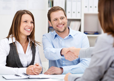 a man and woman shaking hands and making a deal